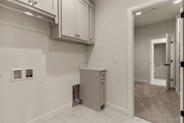 laundry room featuring light carpet, hookup for a washing machine, and cabinets