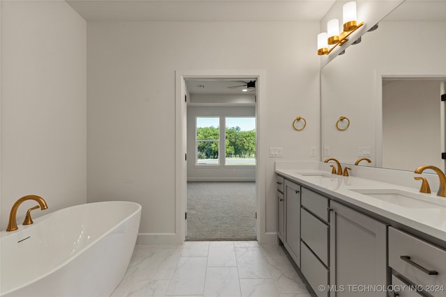 bathroom with vanity, ceiling fan, and a bathtub