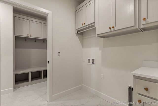 laundry room with washer hookup and cabinets