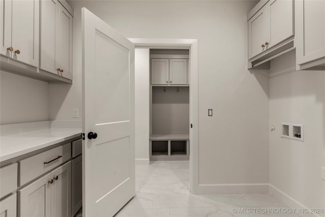 laundry area featuring hookup for a washing machine and cabinets