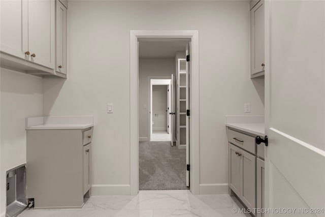 laundry area featuring light colored carpet