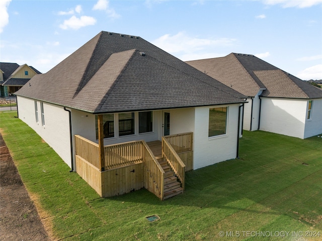 rear view of property with a yard