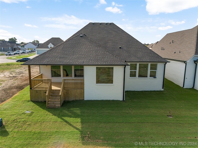 rear view of house with a yard