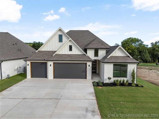 view of front of home with a front lawn and a garage