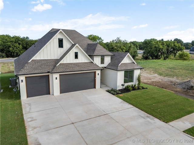 view of front of home with a garage and a front yard