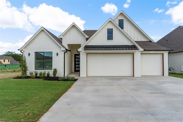 modern farmhouse style home featuring a garage and a front lawn