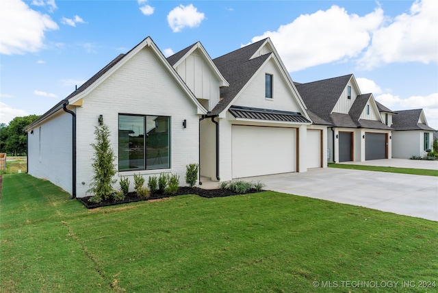 modern farmhouse style home with a front yard and a garage