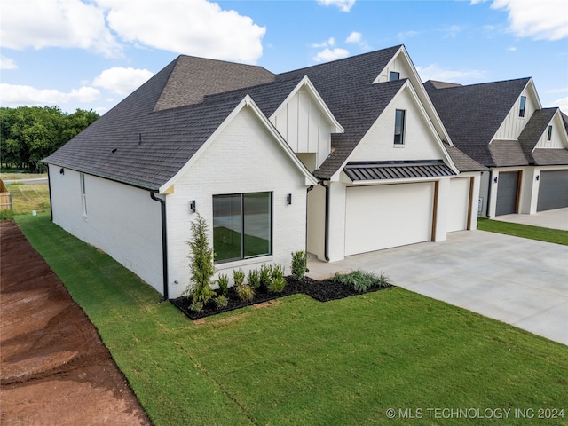 modern farmhouse featuring a garage and a front yard