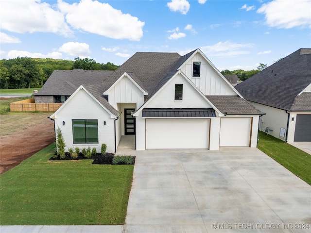 modern farmhouse with a garage and a front lawn