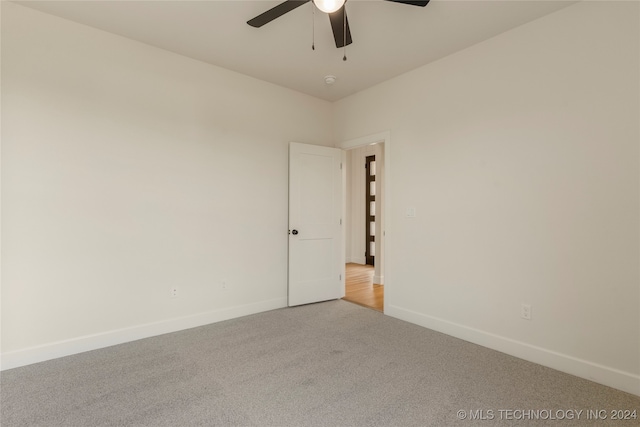 spare room featuring carpet flooring and ceiling fan