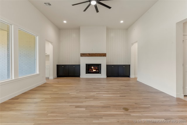 unfurnished living room featuring ceiling fan and light hardwood / wood-style flooring