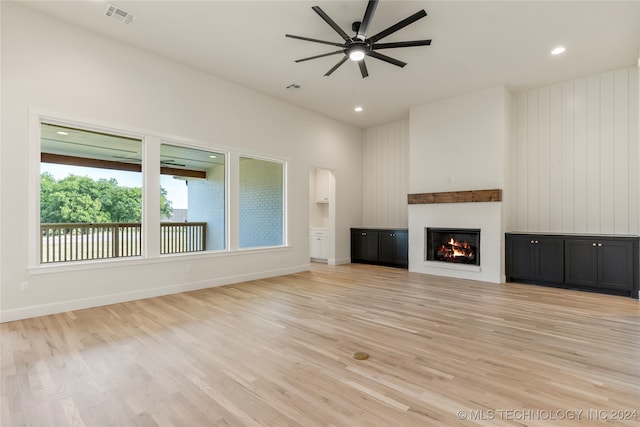 unfurnished living room with ceiling fan and light hardwood / wood-style floors