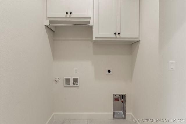 clothes washing area featuring washer hookup, electric dryer hookup, cabinets, and hookup for a gas dryer