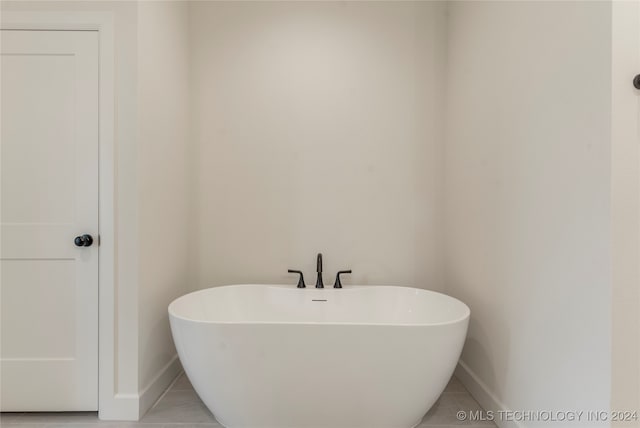 bathroom featuring tile patterned flooring and a bathtub