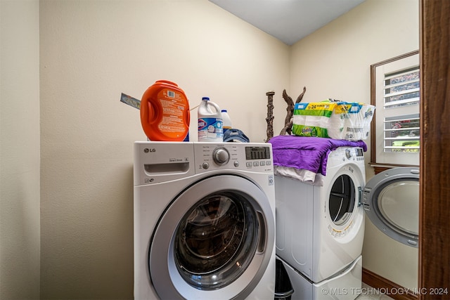 clothes washing area featuring washer and dryer