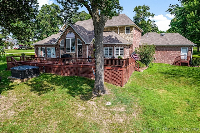 rear view of house featuring a lawn and a wooden deck