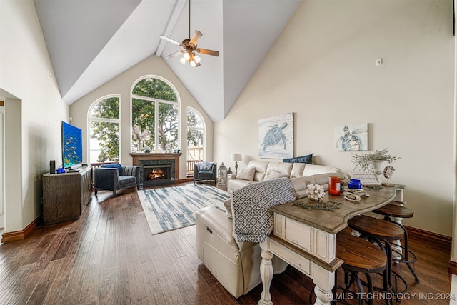 dining space featuring dark hardwood / wood-style flooring, high vaulted ceiling, and ceiling fan