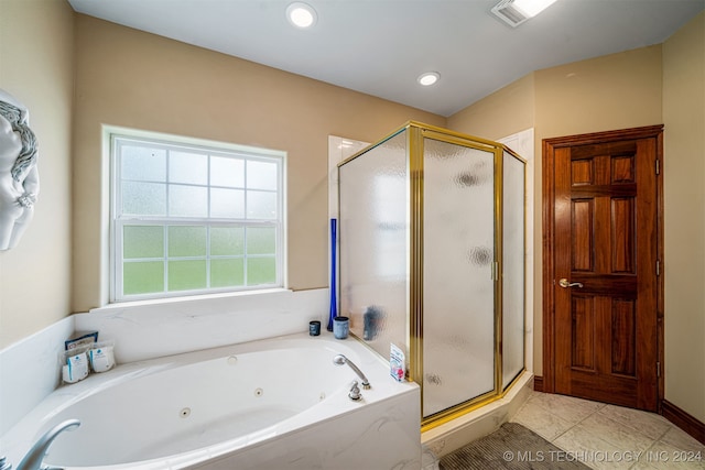 bathroom with tile patterned flooring and shower with separate bathtub