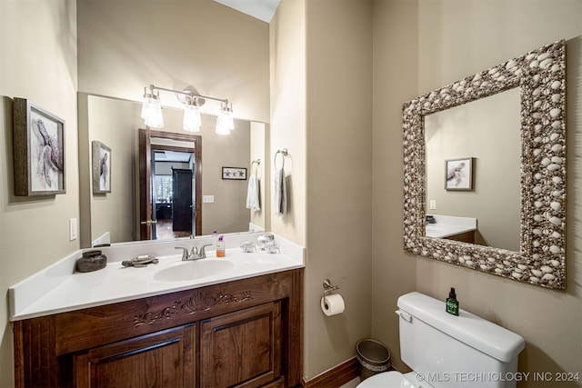 bathroom featuring vanity and toilet