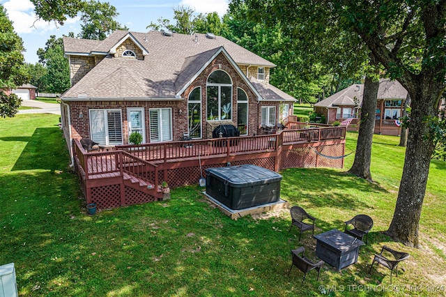 back of property featuring a fire pit, a wooden deck, and a yard