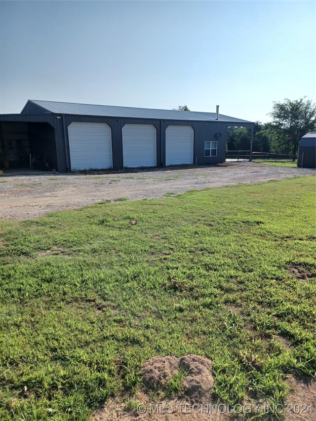 garage featuring a lawn