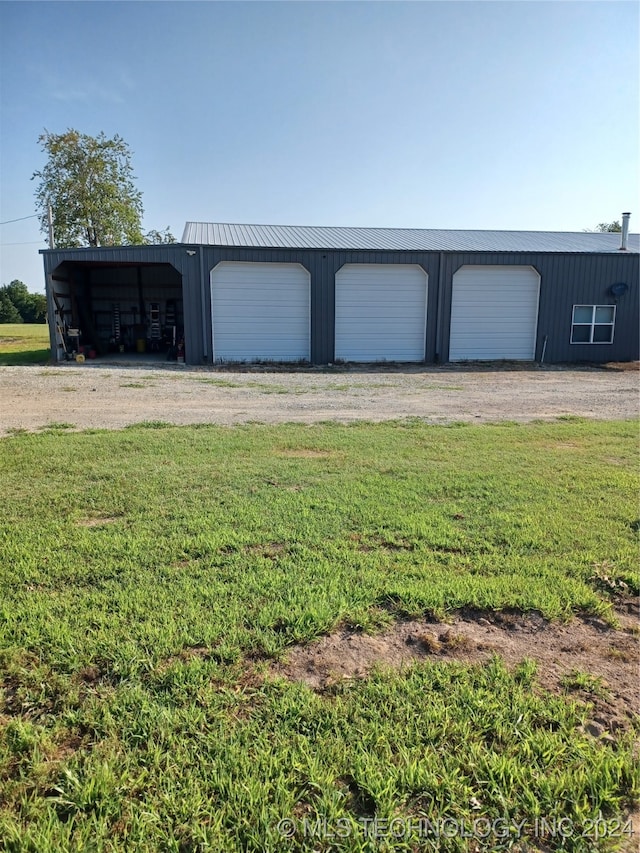 view of outbuilding featuring a garage and a lawn