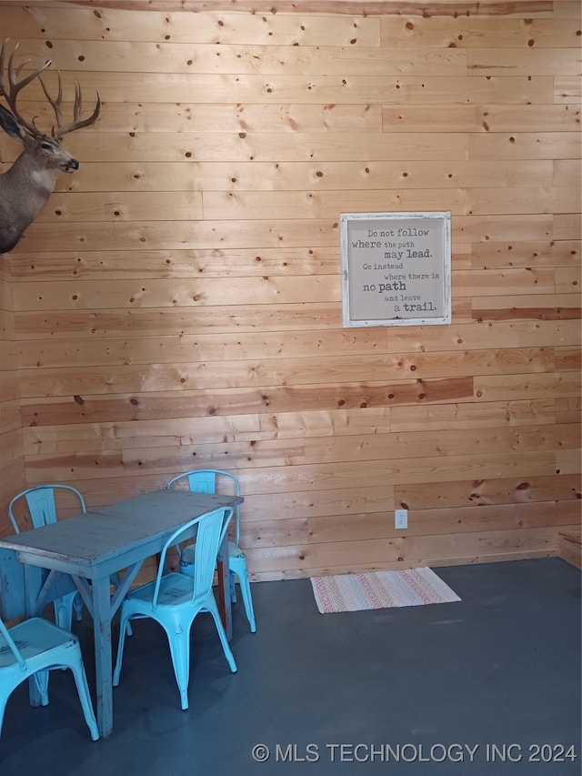 unfurnished dining area with wooden walls