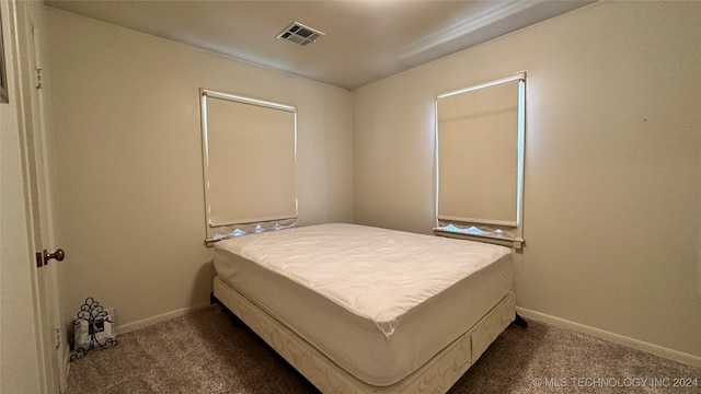 bedroom with dark colored carpet