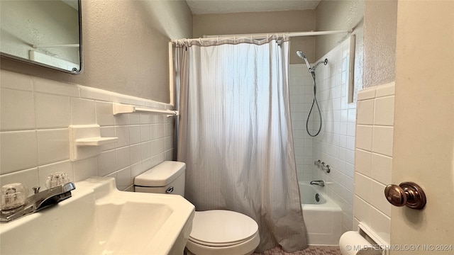 full bathroom with toilet, tasteful backsplash, shower / bath combo with shower curtain, sink, and tile walls