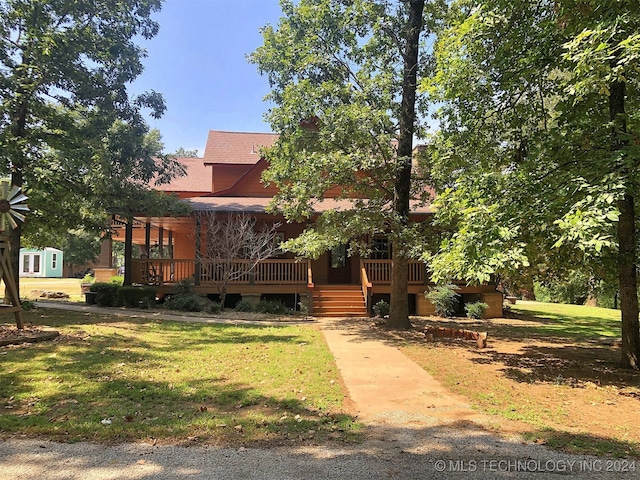 view of front facade featuring a front yard and a deck