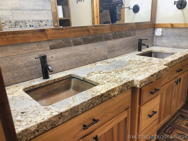 interior space featuring light stone counters, tasteful backsplash, and sink