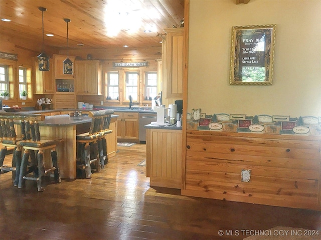 kitchen featuring a kitchen breakfast bar, dishwasher, light brown cabinetry, wood ceiling, and hardwood / wood-style flooring