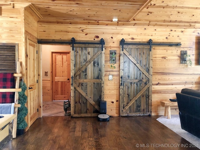 interior space with a barn door, wood ceiling, and dark hardwood / wood-style flooring