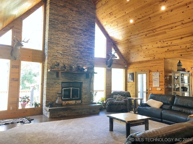 living room with a wealth of natural light, high vaulted ceiling, and a fireplace