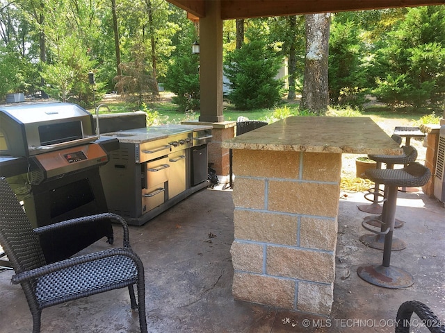 view of patio / terrace featuring area for grilling and a grill