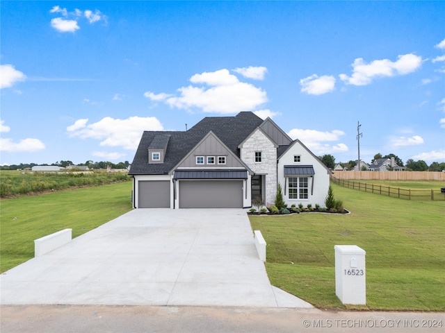 view of front of property with a front yard and a garage