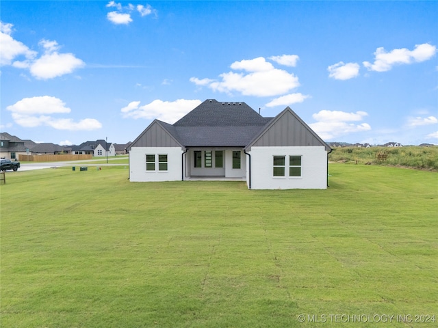 rear view of house with a yard