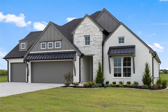 view of front of property with a front yard and a garage