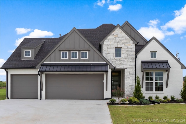 view of front of property featuring a garage and a front yard