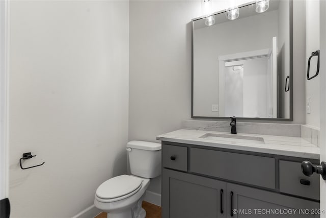 bathroom featuring vanity and toilet