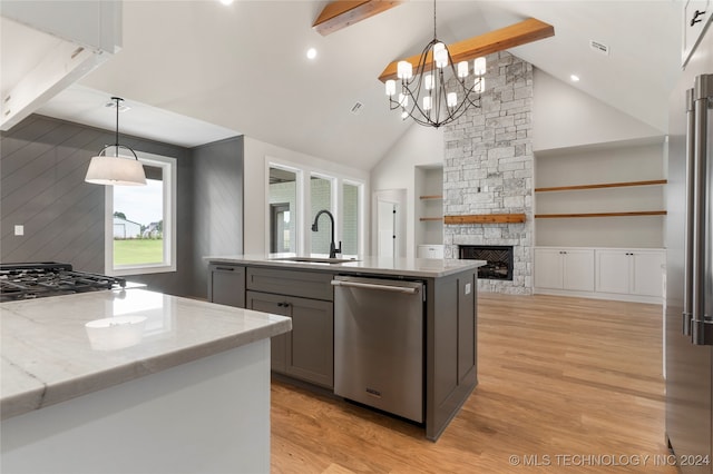 kitchen with dishwasher, beam ceiling, sink, a chandelier, and light wood-type flooring