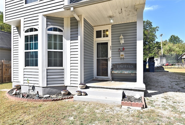 property entrance with a patio area and a lawn