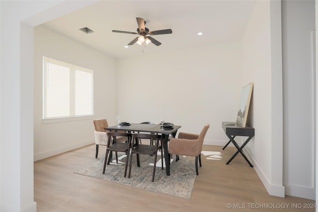 dining area with light hardwood / wood-style flooring and ceiling fan