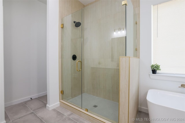 bathroom with tile patterned floors and independent shower and bath