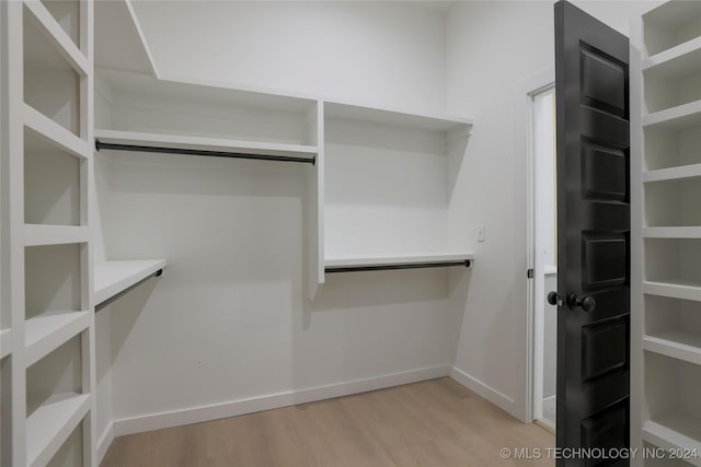 spacious closet with light hardwood / wood-style floors