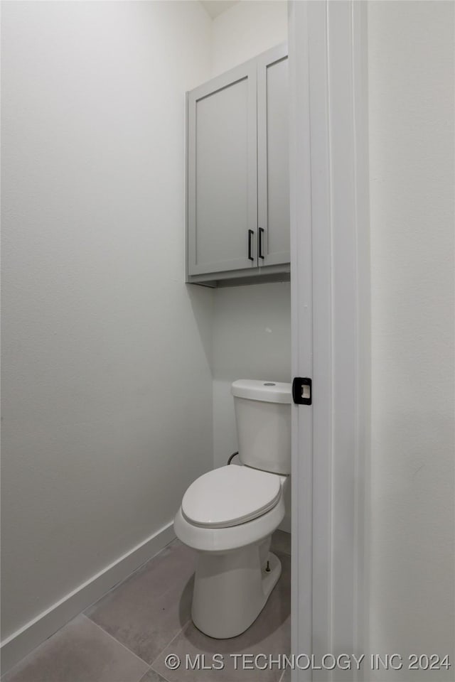 bathroom with tile patterned flooring and toilet