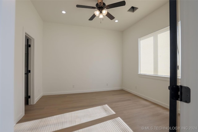 unfurnished room with ceiling fan and light wood-type flooring