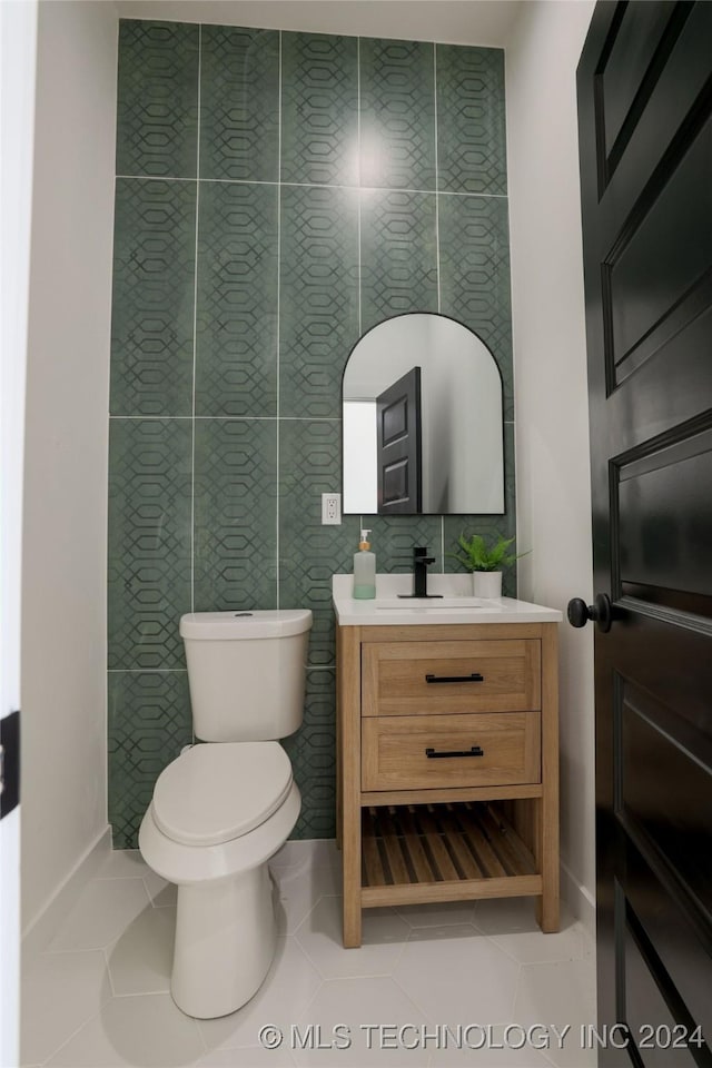 bathroom featuring tile patterned flooring, vanity, and toilet