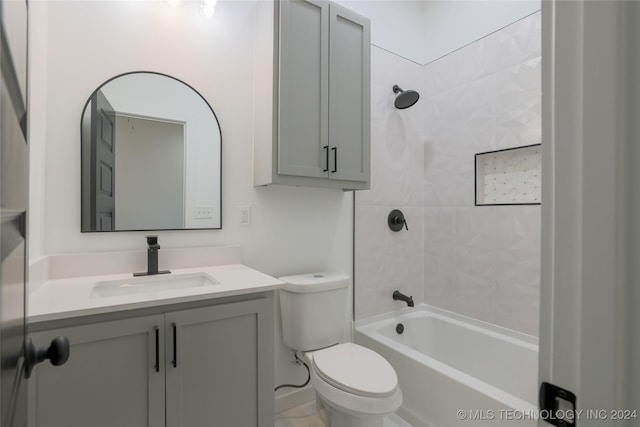 full bathroom with vanity, toilet, and tiled shower / bath combo