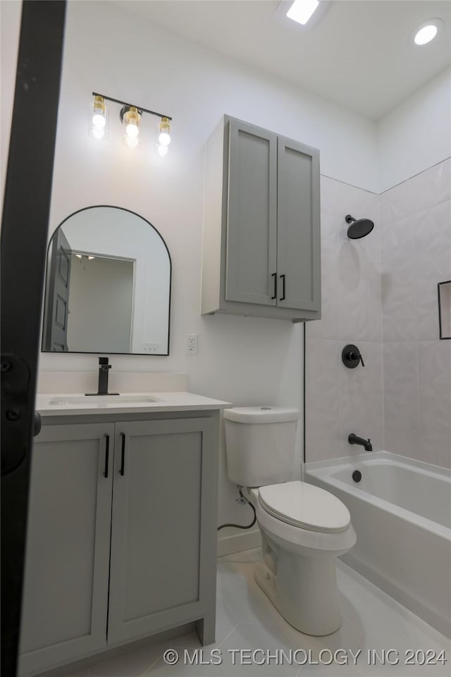 full bathroom with vanity, tiled shower / bath combo, toilet, and tile patterned flooring